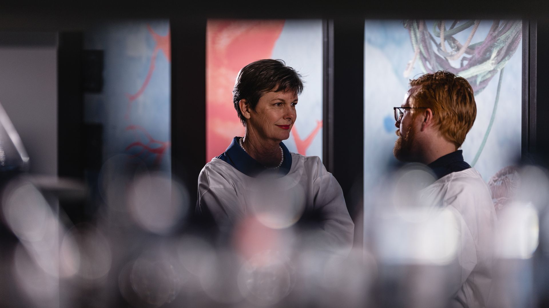 Scientists discuss their work in the background