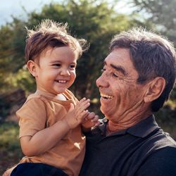A grandfather holds his grandchild