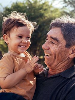 A grandfather holds his grandchild