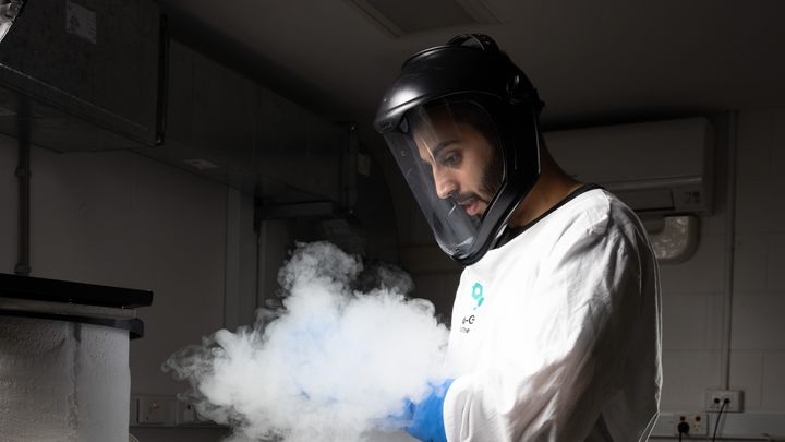 A scientist stores material in ultracold storage