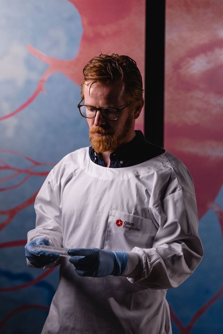 A male scientist stares at his work